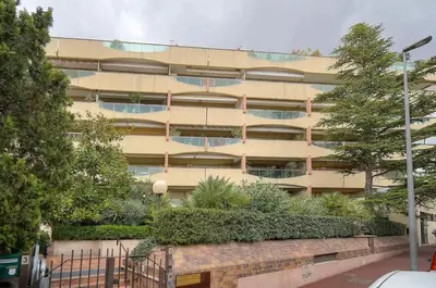 an apartment building with a garden in front of it at One Bed Apt in the center of Cannes - 2198 in Cannes