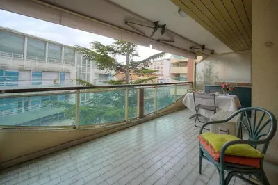 a balcony with a table and chairs in a building at One Bed Apt in the center of Cannes - 2198 in Cannes