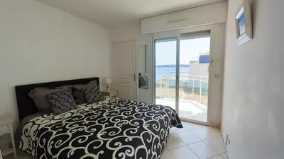 a small kitchen with white cabinets and a refrigerator at Villa Norma in Cannes
