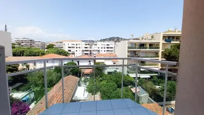 a bedroom with a bed and a large window at Villa Norma in Cannes