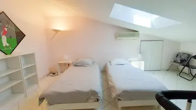 a white room with two beds in it at Villa Norma in Cannes
