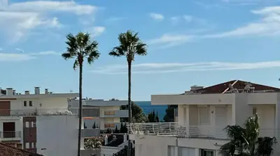 two palm trees in a city with buildings at Top Floor Secret Garden, Cannes in Cannes