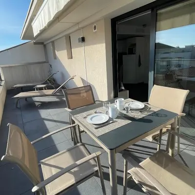 a table and chairs sitting on a balcony with a table and chairs at Top Floor Secret Garden, Cannes in Cannes