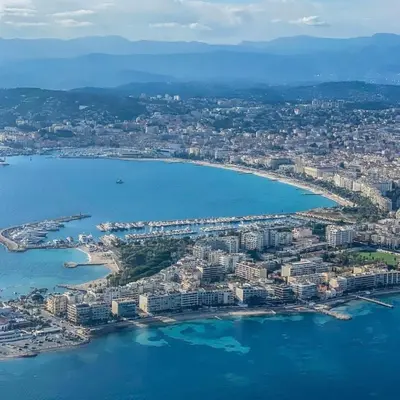 an aerial view of a city next to the water at Top Floor Secret Garden, Cannes in Cannes