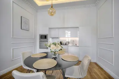 a dining room with a black table and chairs at Elégant 2 chambres PARKING, Clémenceau- CENTRE CANNES A2B248 in Cannes