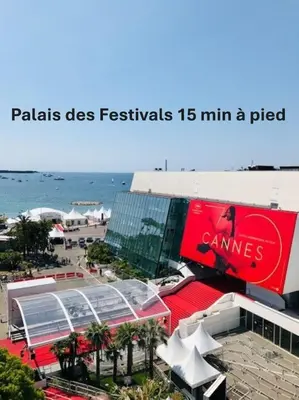a picture of a building with amsg sign and the beach at Elégant 2 chambres PARKING, Clémenceau- CENTRE CANNES A2B248 in Cannes