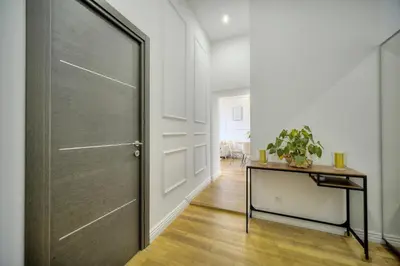 a hallway with a door and a table with a plant at Elégant 2 chambres PARKING, Clémenceau- CENTRE CANNES A2B248 in Cannes
