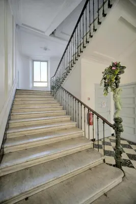 a staircase in a building with a plant on it at Elégant 2 chambres PARKING, Clémenceau- CENTRE CANNES A2B248 in Cannes