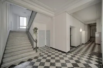 a hallway with stairs and a checkered floor at Elégant 2 chambres PARKING, Clémenceau- CENTRE CANNES A2B248 in Cannes