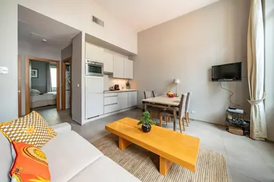 a living room with a couch and a table at Beautiful 2 bedroom in the heart of Cannes in Cannes