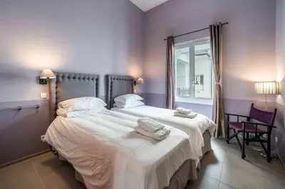 a bedroom with a large bed with two towels on it at Beautiful 2 bedroom in the heart of Cannes in Cannes