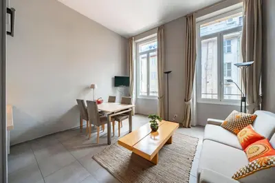 a living room with a couch and a table at Beautiful 2 bedroom in the heart of Cannes in Cannes