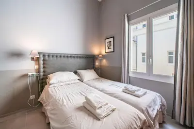 a bedroom with a bed with towels on it at Beautiful 2 bedroom in the heart of Cannes in Cannes