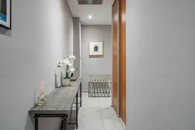 a hallway with a long table with flowers on it at Beautiful 2 bedroom in the heart of Cannes in Cannes