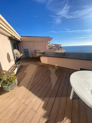 a living room with a table and a couch at La Perla del Mare in Cannes