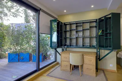 a home office with a desk and a large window at Superbe appartement T5 proche du Palais et de la Croisette in Cannes