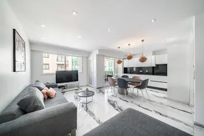 a living room with a couch and a table at Beautiful 3 bedroom close to the Martinez in Cannes