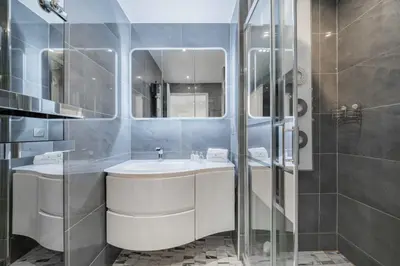a bathroom with a sink and a glass shower at Beautiful 3 bedroom close to the Martinez in Cannes