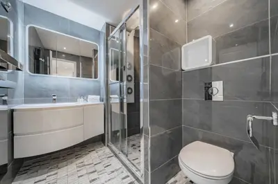 a bathroom with a toilet and a sink and a shower at Beautiful 3 bedroom close to the Martinez in Cannes