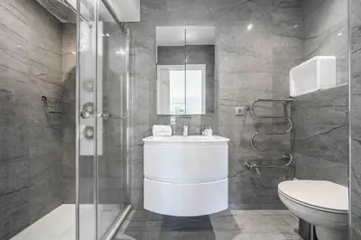 a bathroom with a toilet and a sink and a shower at Beautiful 3 bedroom close to the Martinez in Cannes