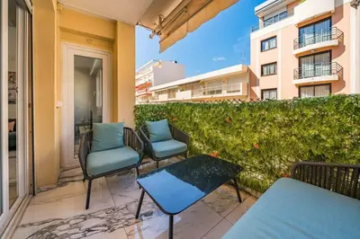 a patio with chairs and tables on a balcony at Beautiful 3 bedroom close to the Martinez in Cannes