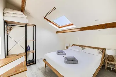 a bedroom with a bed and a skylight at Charming apartment heart of Suquet neighborhood in Cannes