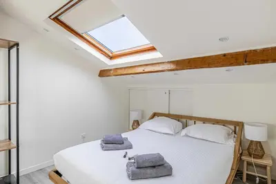 a bedroom with a bed with two towels on it at Charming apartment heart of Suquet neighborhood in Cannes