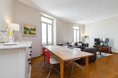a living room with a table and a couch at 77 Avenue de Grasse in Cannes