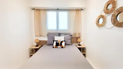 a bedroom with a bed with a teddy bear on it at Le Palais Des Iles in Cannes