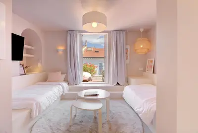 a white room with two beds and a window at Alma Florian apartment 4 people with terrace in Cannes