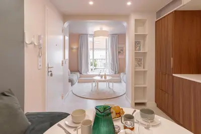a kitchen and living room with a table with cups and plates at Alma Florian apartment 4 people with terrace in Cannes