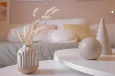 a white vase with two eggs on a table at Alma Florian apartment 4 people with terrace in Cannes
