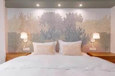 a bedroom with a large white bed with two lamps at Alma Florian apartment 4 people with terrace in Cannes