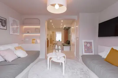a living room with a couch and a table at Alma Florian apartment 4 people with terrace in Cannes