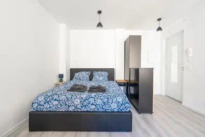 a bedroom with a bed with a blue comforter at Studio centre Cannes in Cannes