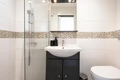 a white bathroom with a sink and a shower at Studio centre Cannes in Cannes