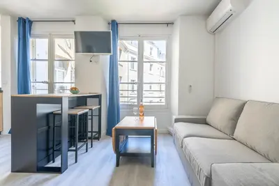 a living room with a couch and a table at Studio centre Cannes in Cannes