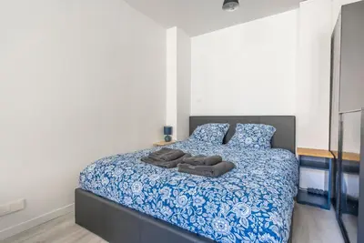 a bedroom with a blue and white bed with two pillows at Studio centre Cannes in Cannes