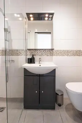 a bathroom with a sink and a mirror and a toilet at Studio centre Cannes in Cannes