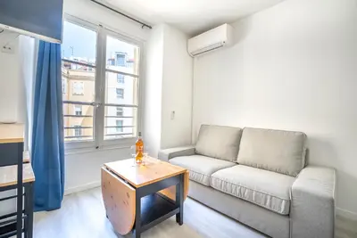 a living room with a couch and a table at Studio centre Cannes in Cannes