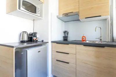 a small kitchen with a refrigerator and a microwave at Studio centre Cannes in Cannes