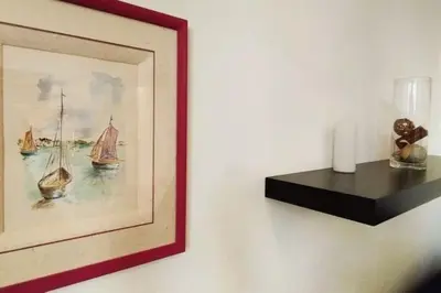 a picture of a painting of boats on a wall at Le Canada - 2Pièces Croisette plage derrière le Carlton calme in Cannes