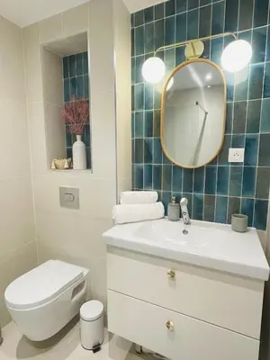 a bathroom with a toilet and a sink and a mirror at Le Week Riviera III -3 étoiles-Plage du midi-Grande terrasse-Piscine-Cannes- Palais des Festivals in Cannes