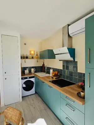 a kitchen with blue cabinets and a white sink at Le Week Riviera III -3 étoiles-Plage du midi-Grande terrasse-Piscine-Cannes- Palais des Festivals in Cannes