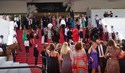 a large group of people walking down the stairs at B042-Functional apartment with balcony Suquet Cannes in Cannes