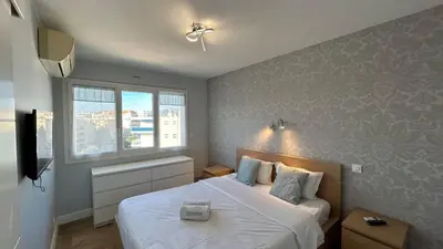 a bedroom with a large white bed with a window at B018-Bright apartment with balcony - Cannes Croisette in Cannes