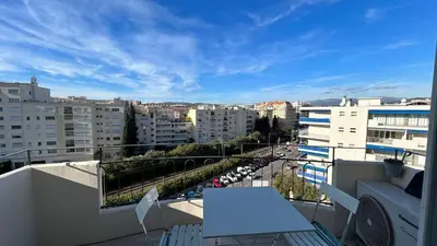 a balcony with a table and a view of a city at B018-Bright apartment with balcony - Cannes Croisette in Cannes