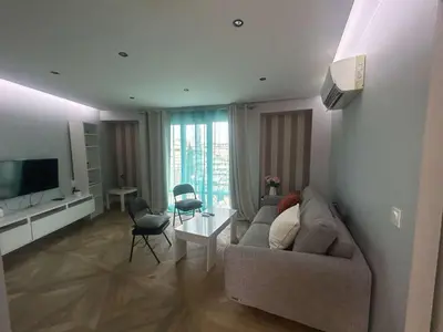 a living room with a couch and a table at B018-Bright apartment with balcony - Cannes Croisette in Cannes