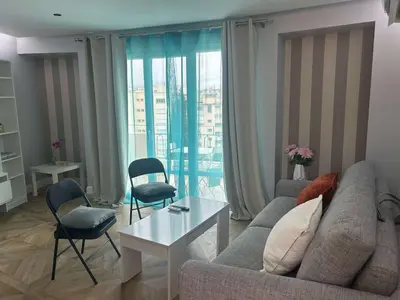 a living room with a couch and a table and chairs at B018-Bright apartment with balcony - Cannes Croisette in Cannes
