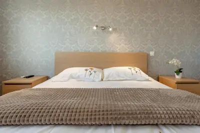 a bedroom with a large bed with two night stands at B018-Bright apartment with balcony - Cannes Croisette in Cannes